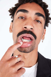 Bottom bridge grillz – detailed gold lower teeth close-up photo