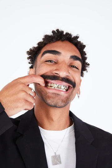 man with top 8 yellow gold grillz